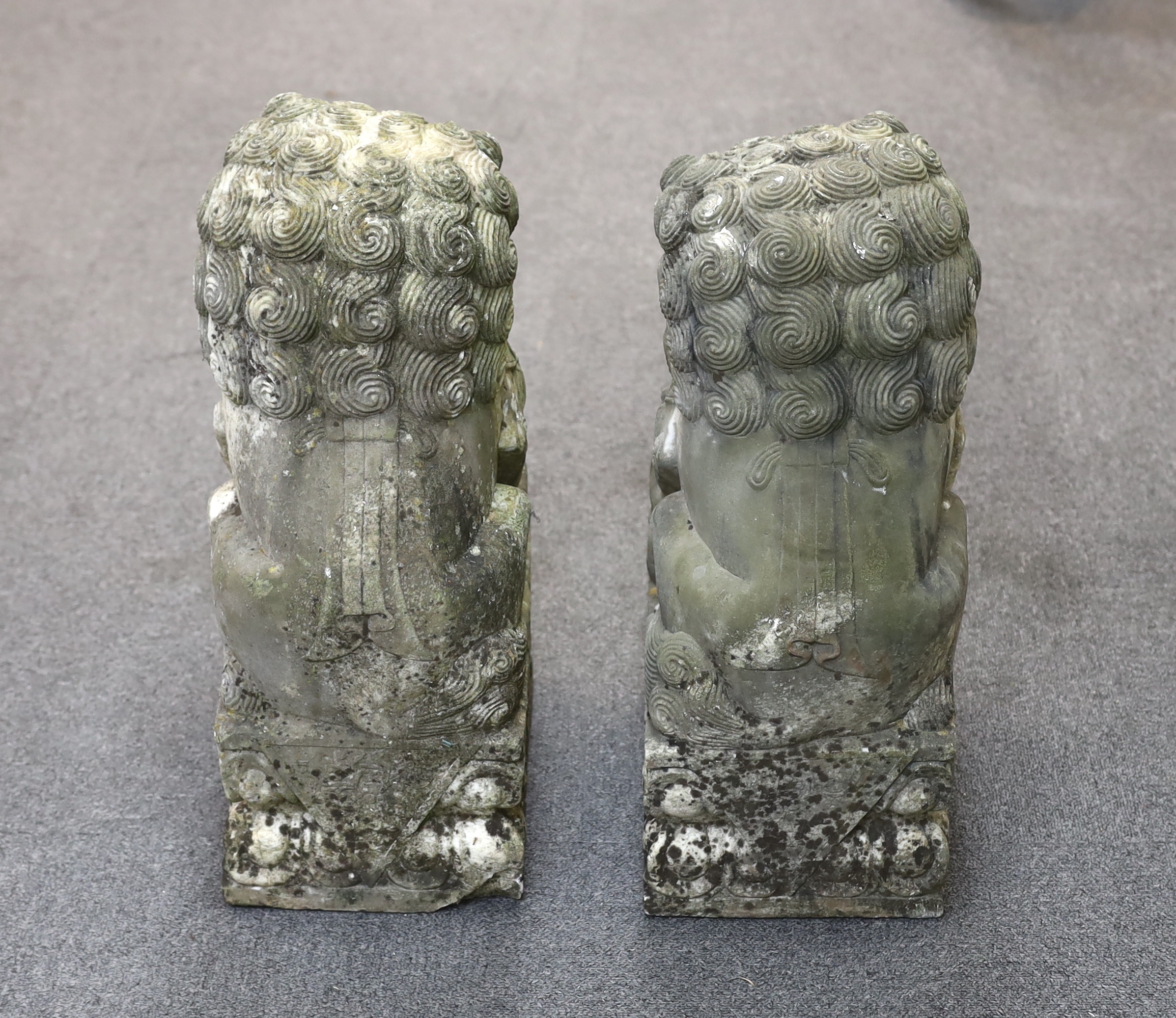 A pair of 20th century Chinese carved marble garden statues modelled as Dogs of Fo, each with weathered finish, 22cm wide, 31cm deep, 54cm high